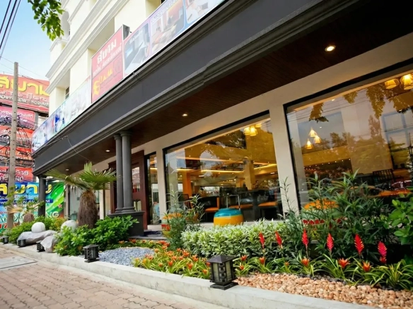 Front view of hotel building on Ngamwongwan Road, ideal investment property with approved plans for a new condominium project.