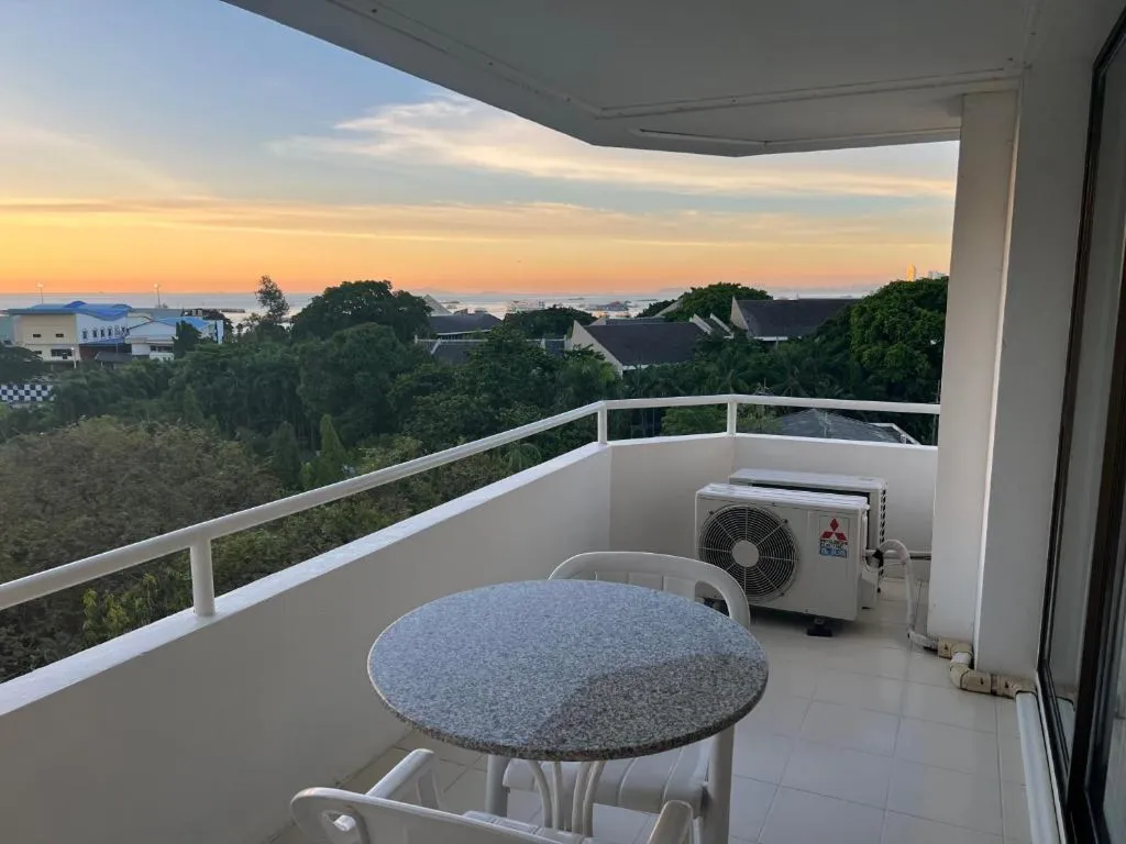 Balcony seating area with sunset city view