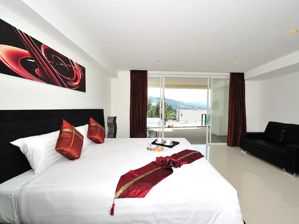 Boutique hotel bedroom with red accent decor