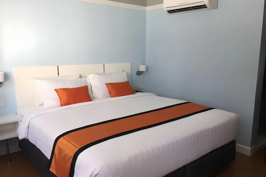 Hotel bedroom with city view and natural light