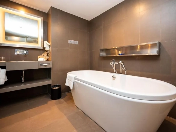 Hotel suite bathroom with bathtub