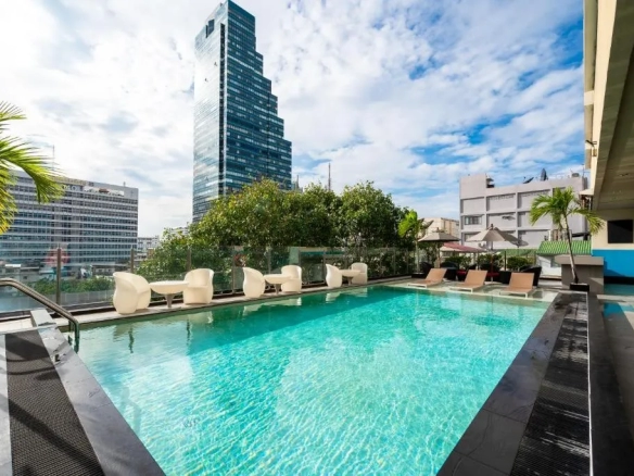 Pool deck relaxation area with city backdrop