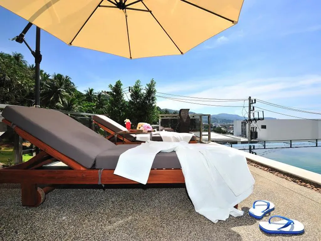 Sunbeds and poolside relaxation area