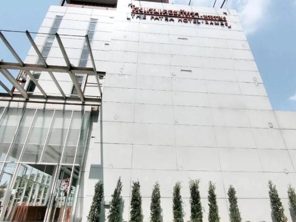 Daytime exterior view of Patra hotel building in urban location