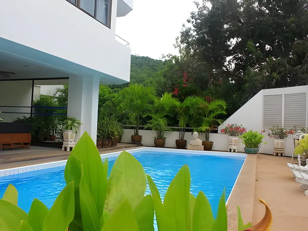 Hotel exterior with garden and poolside area