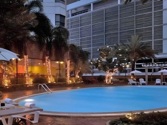 Luxury hotel swimming pool at night in Pratunam