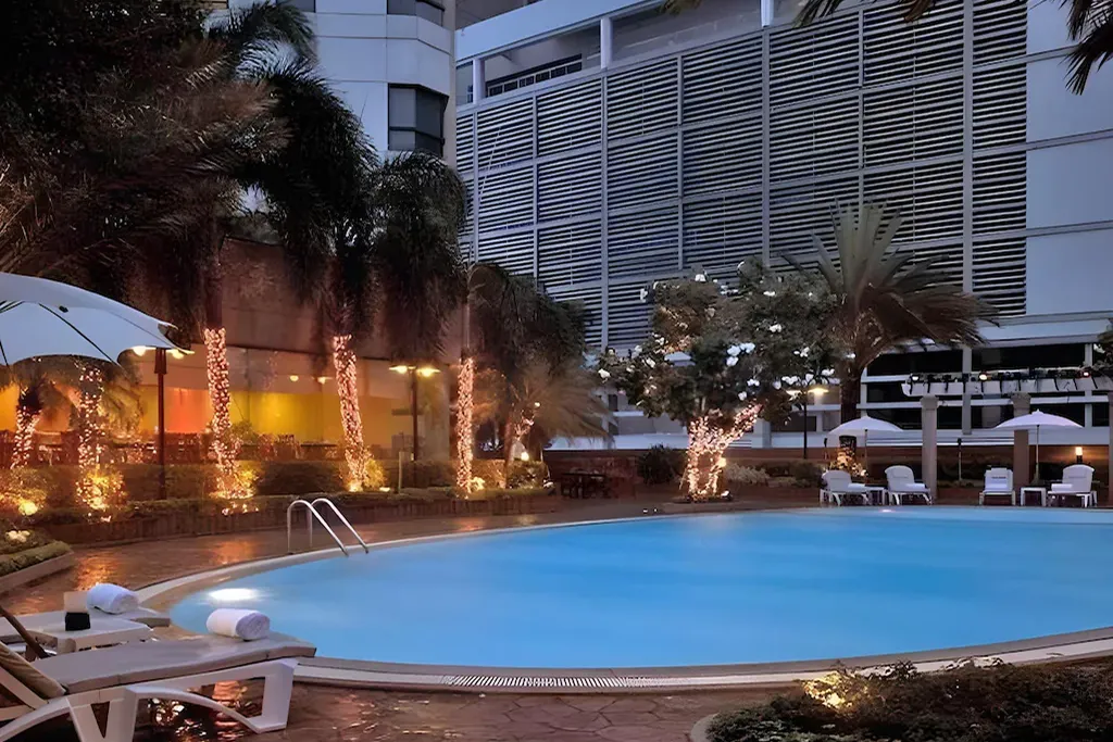 Luxury hotel swimming pool at night in Pratunam