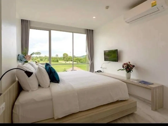 Modern hotel bedroom with natural light and window view