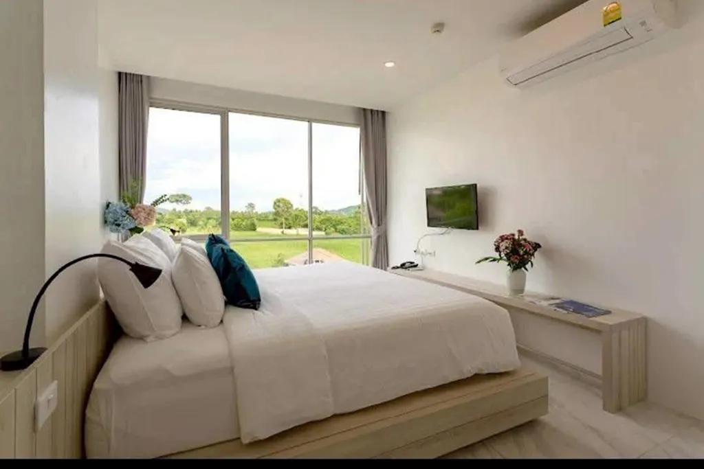Modern hotel bedroom with natural light and window view