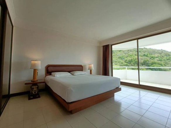 Hotel bedroom with large bed and window