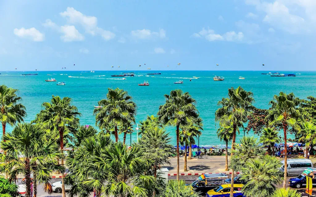 Pattaya Beach with palm trees near boutique hotel