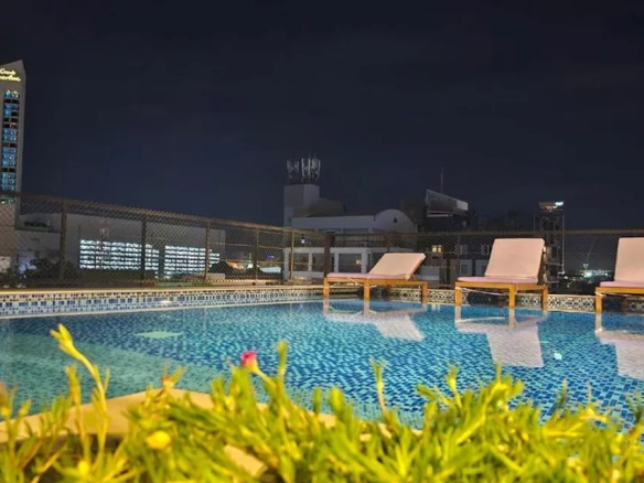 Rooftop pool with sunbeds at night in North Pattaya
