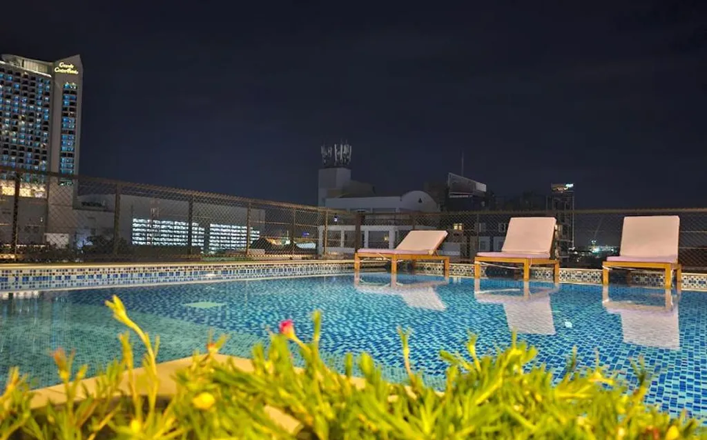 Rooftop pool with sunbeds at night in North Pattaya