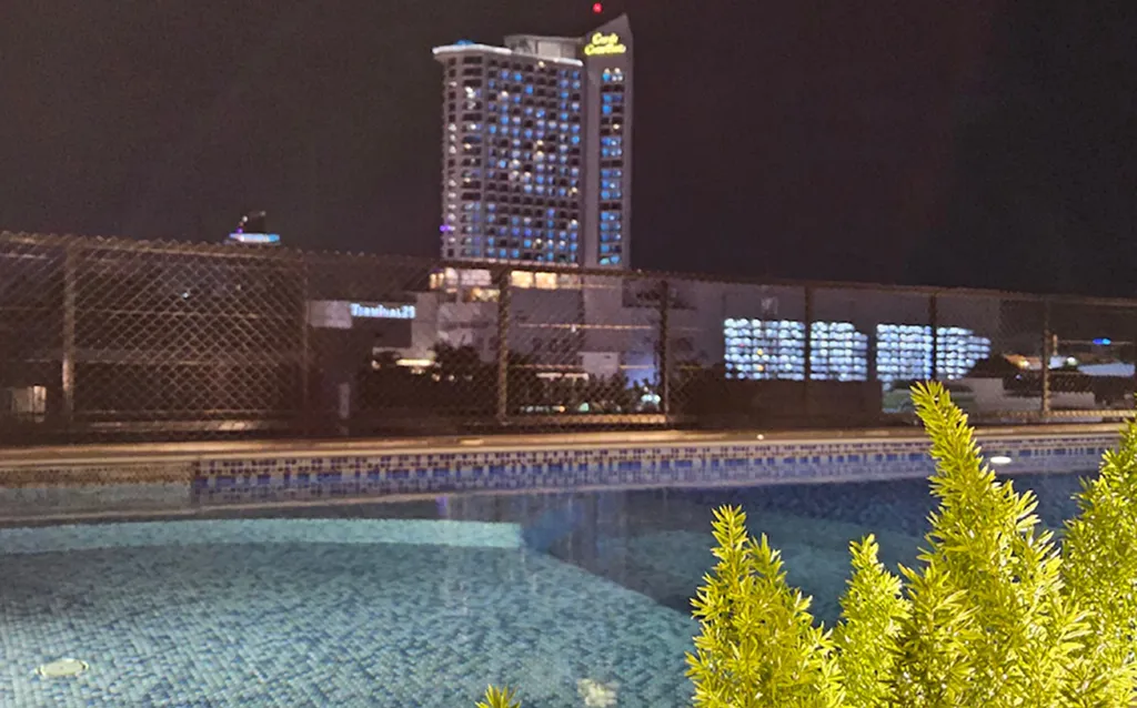 Rooftop pool city view at night in North Pattaya