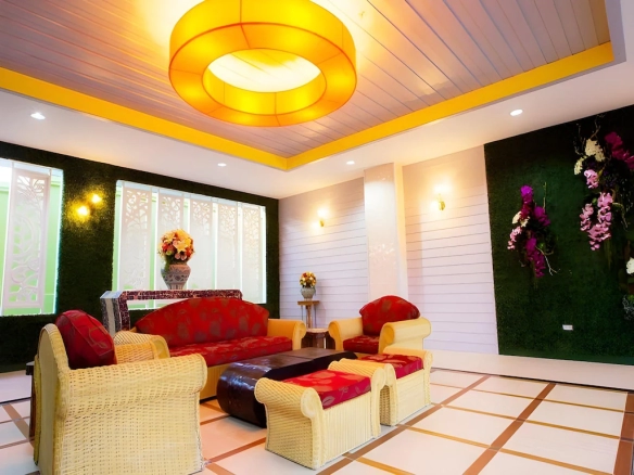 Lobby area of The Ninth Pattaya Hotel Pattaya with modern seating and warm lighting