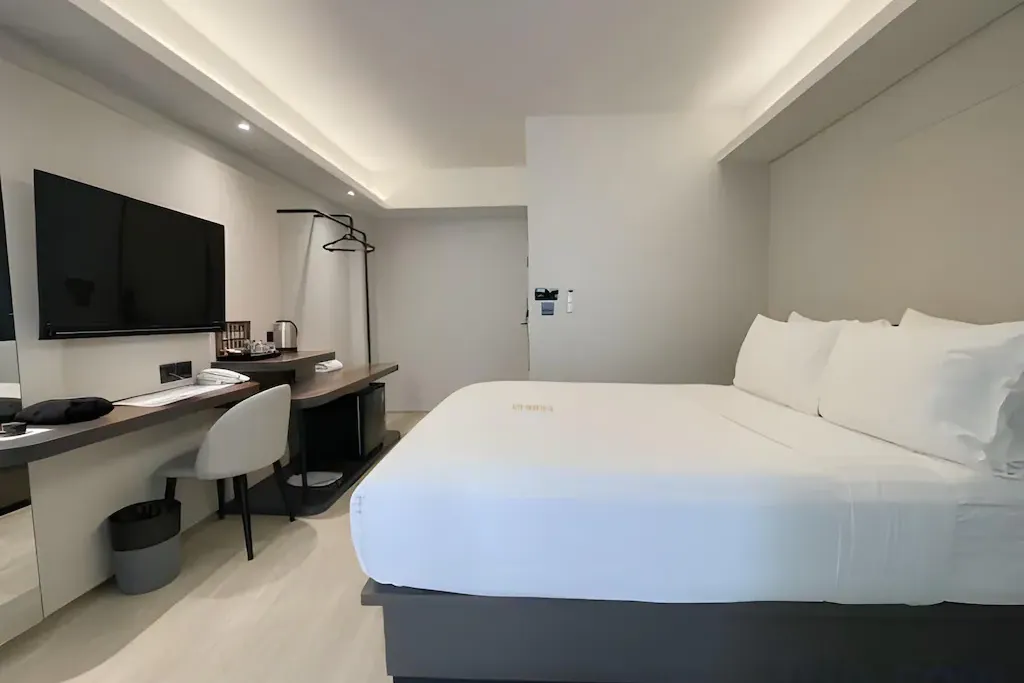 Guest room interior showing compact room configuration of hotel for sale in Bangkok Noi Bangkok