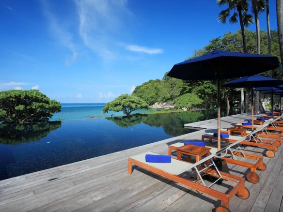 Resort pool sunbeds overlooking the sea in Phuket