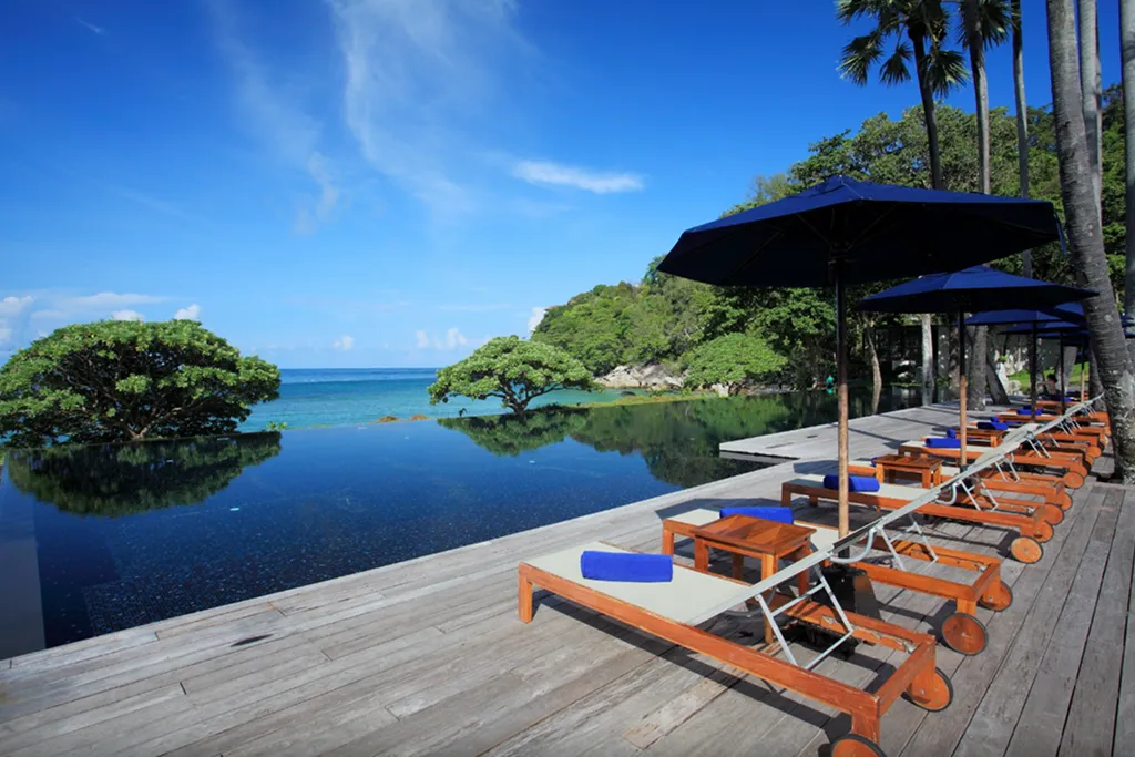 Resort pool sunbeds overlooking the sea in Phuket