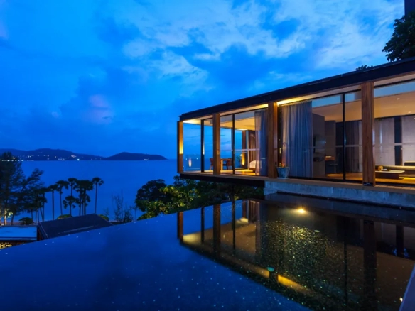 Luxury seaside villa with infinity pool at night in Phuket