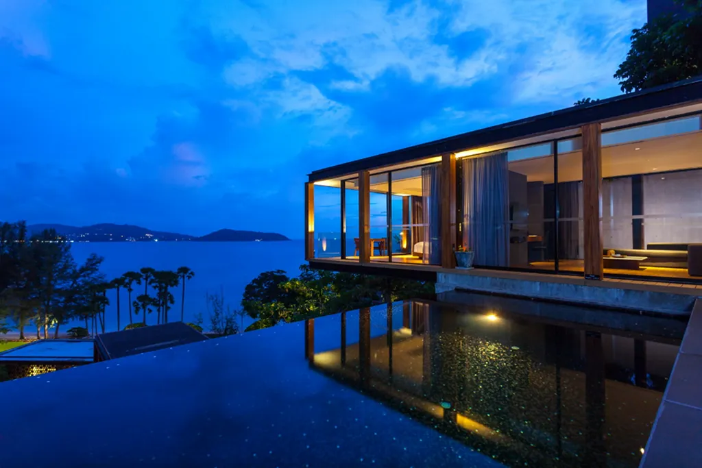 Luxury seaside villa with infinity pool at night in Phuket