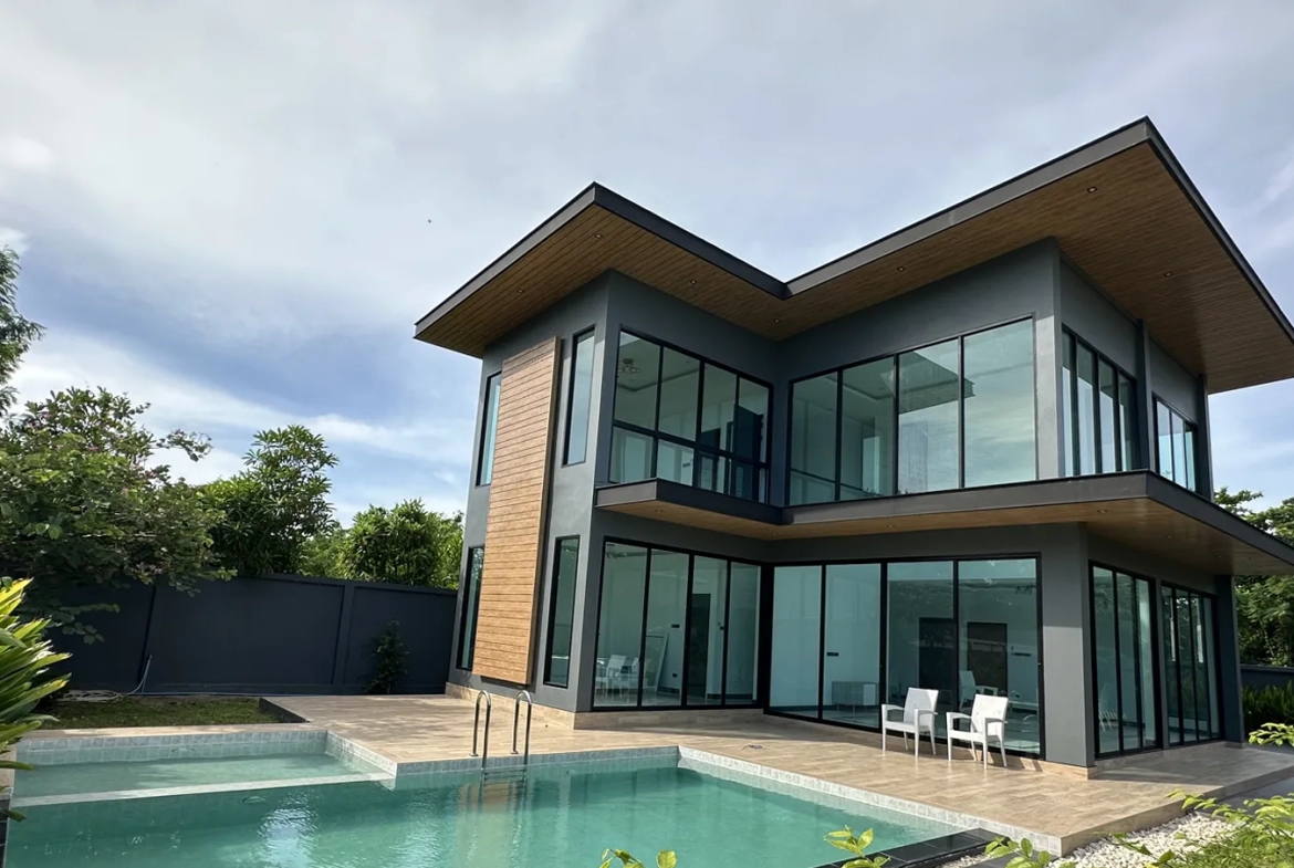 Exterior view with swimming pool and building layout of villa for sale in Bang Lamung Chonburi