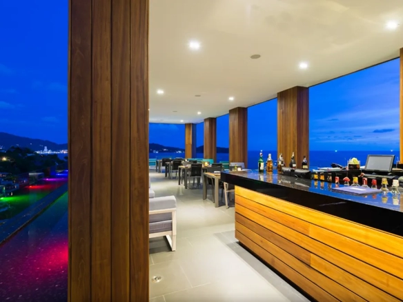 Rooftop bar with panoramic sea view at night in Phuket luxury resort
