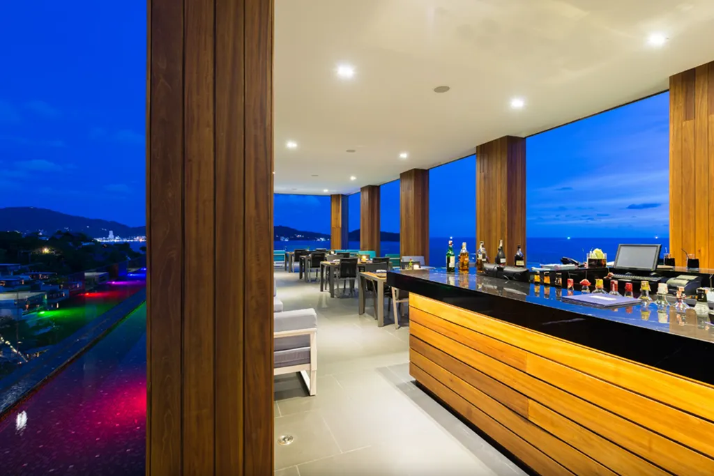 Rooftop bar with panoramic sea view at night in Phuket luxury resort