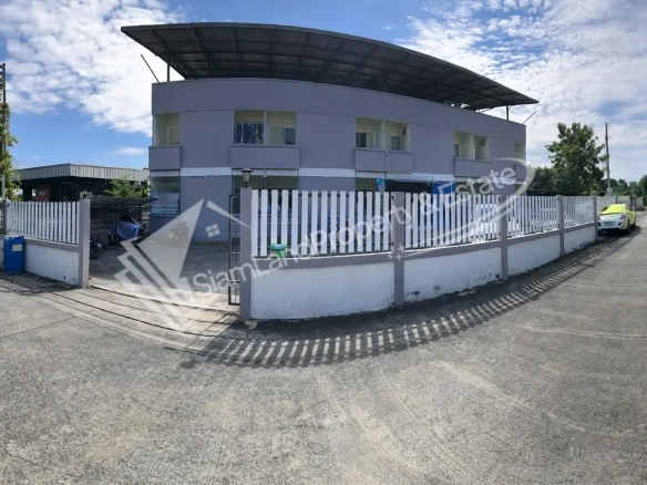 Min Buri 32-room apartment building exterior featuring a spacious concrete front courtyard
