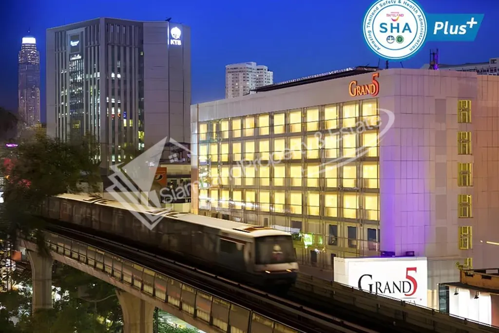 Grand 5 Hotel Plaza building exterior view next to Bangkok BTS skytrain line
