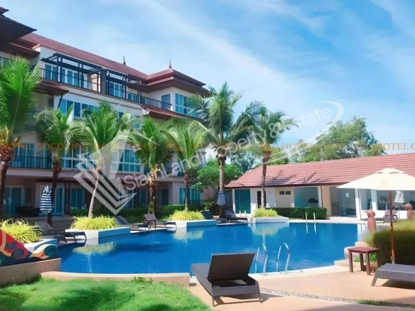 Hotel Coco Phuket Bangtao Beach main outdoor swimming pool and modern resort buildings