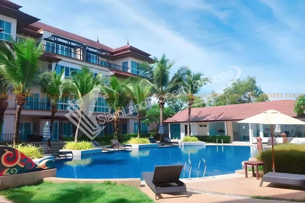 Hotel Coco Phuket Bangtao Beach main outdoor swimming pool and modern resort buildings