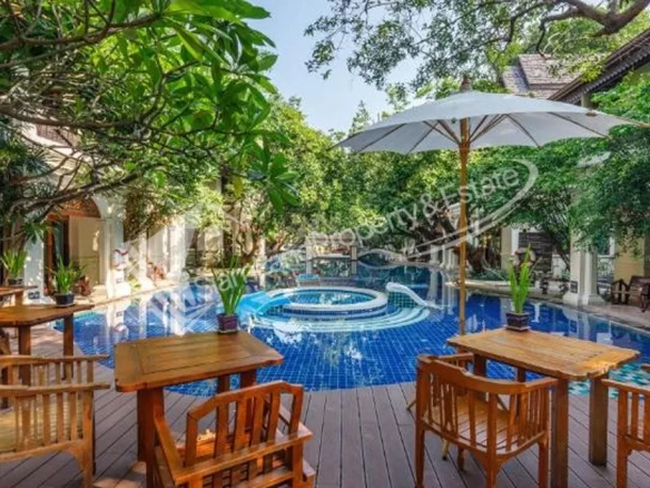 Khum Phaya Resort main tropical swimming pool surrounded by traditional Lanna style buildings