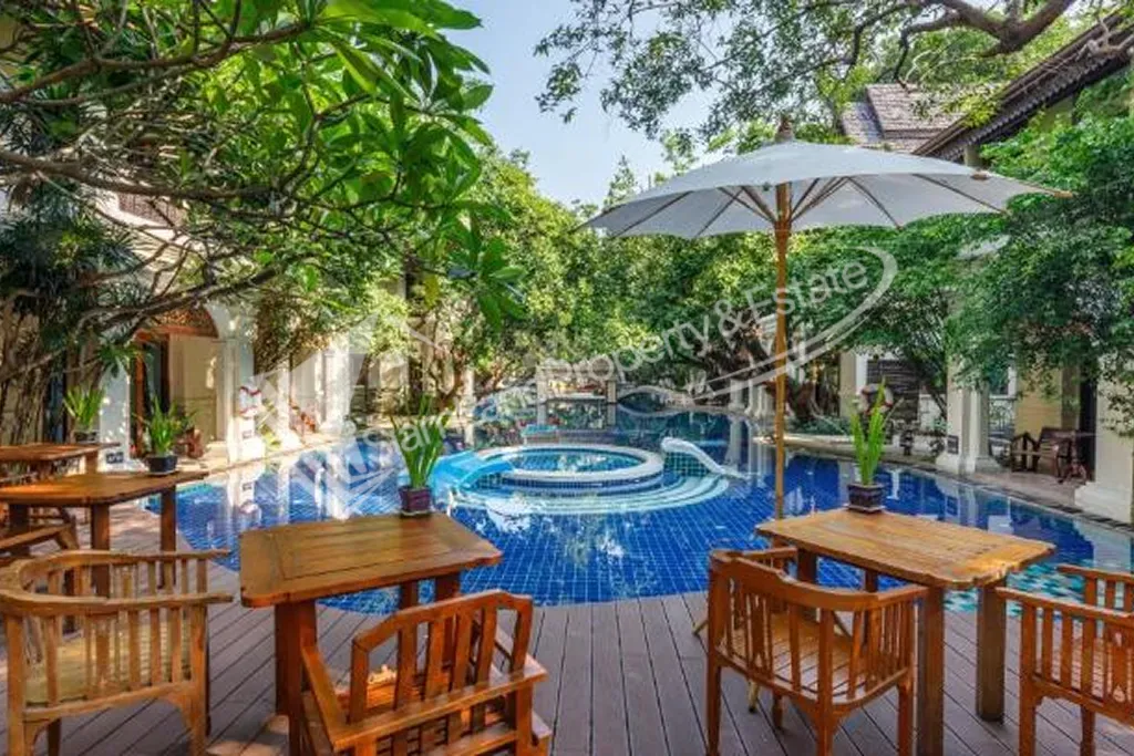 Khum Phaya Resort main tropical swimming pool surrounded by traditional Lanna style buildings