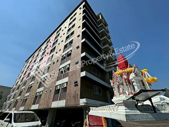 M.T. Court Apartment main building exterior structure featuring a traditional Thai shrine setup
