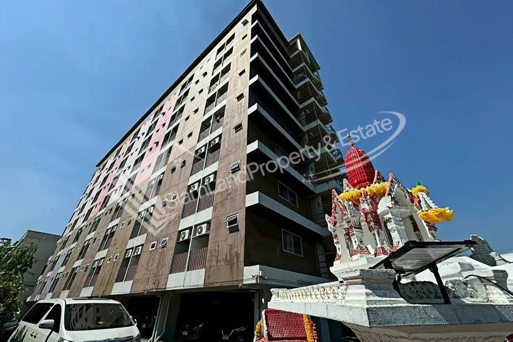 M.T. Court Apartment main building exterior structure featuring a traditional Thai shrine setup