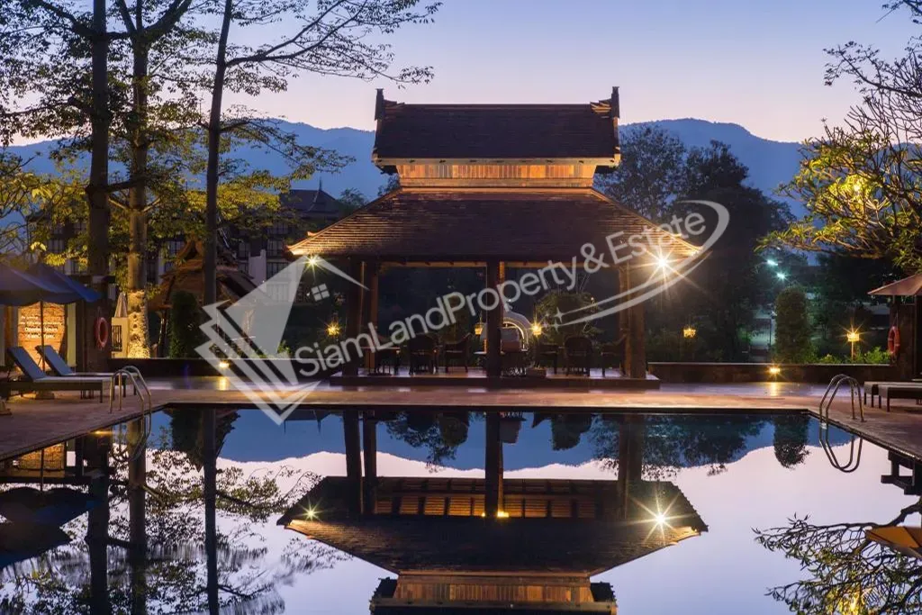 Sibsaen Luxury Rimping Hotel stunning riverside swimming pool and traditional Lanna pavilion under twilight sky