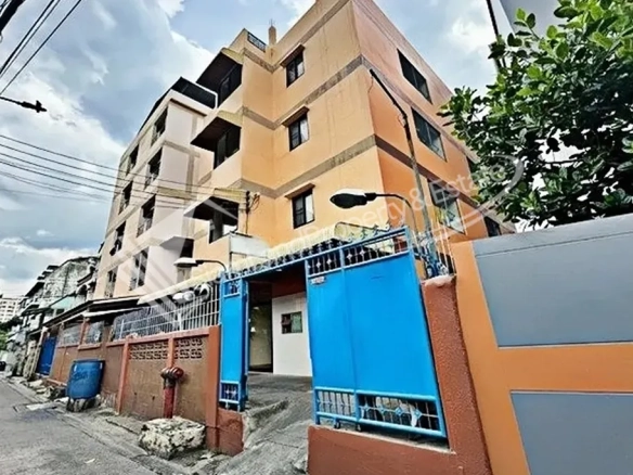Thai Chamber of Commerce area apartment building exterior featuring a secure blue front gate