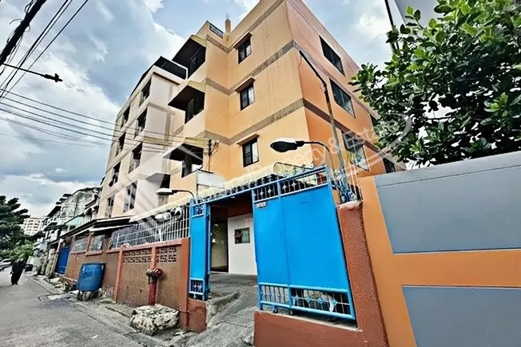 Thai Chamber of Commerce area apartment building exterior featuring a secure blue front gate