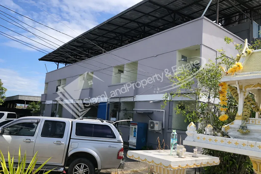 Front perspective of the multi-story apartment building with a traditional Thai shrine setup