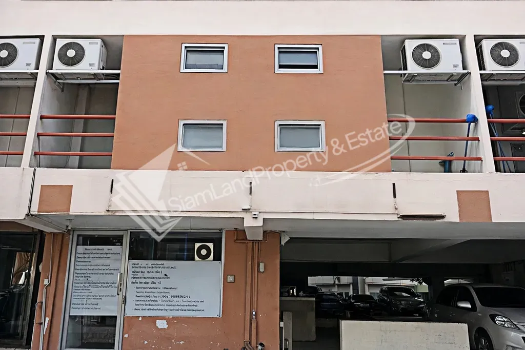 Ground floor building frontage showcasing resident balconies and secure ground entrance areas